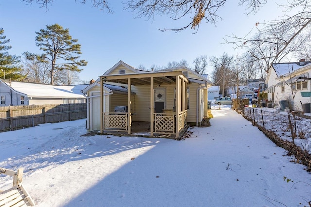 view of snow covered rear of property