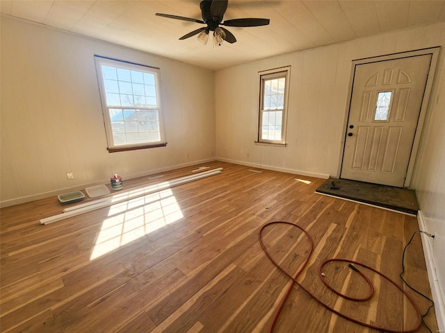 entryway featuring baseboards, plenty of natural light, a ceiling fan, and hardwood / wood-style floors