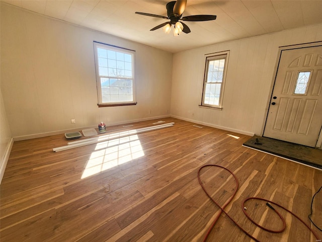 foyer entrance with baseboards, ceiling fan, and hardwood / wood-style floors