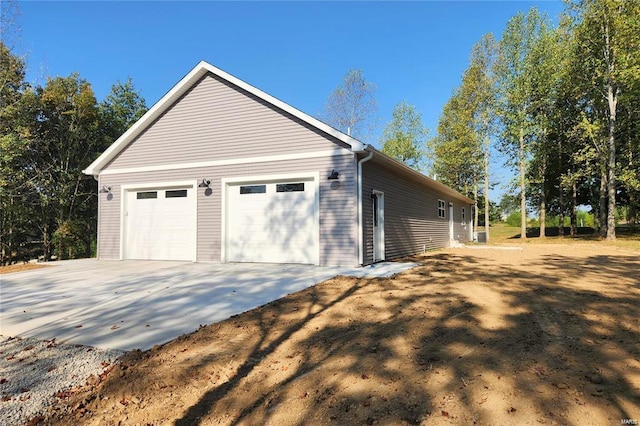 view of property exterior with a garage and an outdoor structure