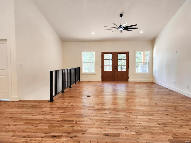 foyer with light hardwood / wood-style floors, ceiling fan, and french doors