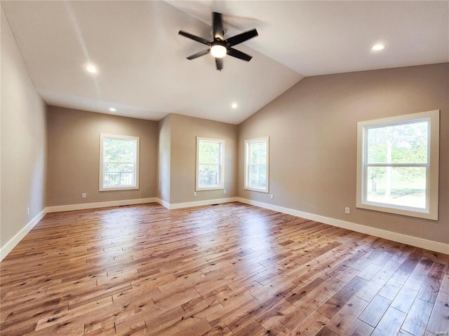 unfurnished room with lofted ceiling, a wealth of natural light, ceiling fan, and light hardwood / wood-style floors