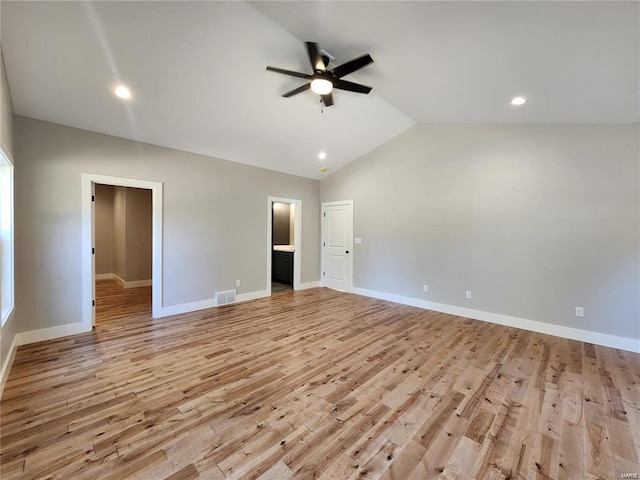 unfurnished bedroom featuring lofted ceiling, light wood-type flooring, ceiling fan, and connected bathroom