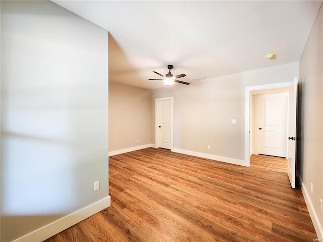 empty room with light hardwood / wood-style floors and ceiling fan