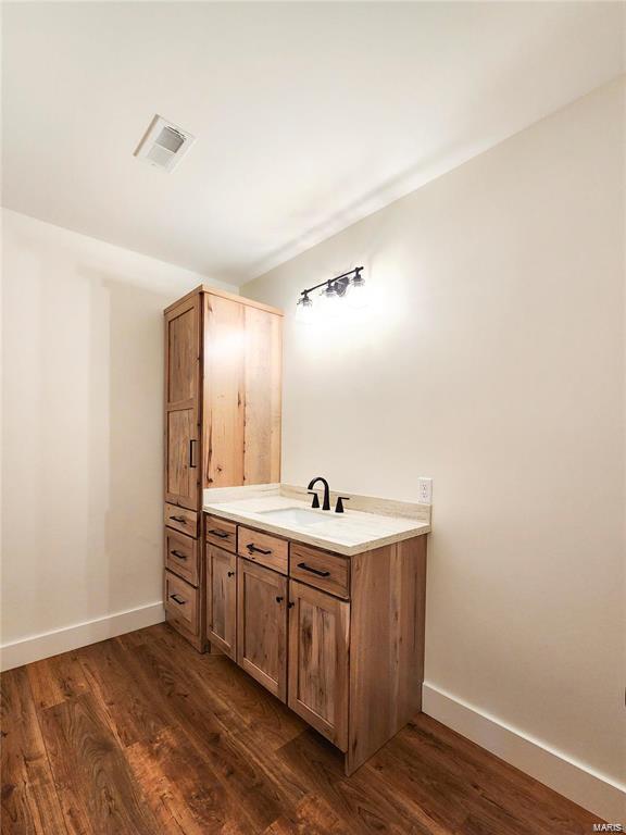 bathroom featuring vanity and hardwood / wood-style flooring