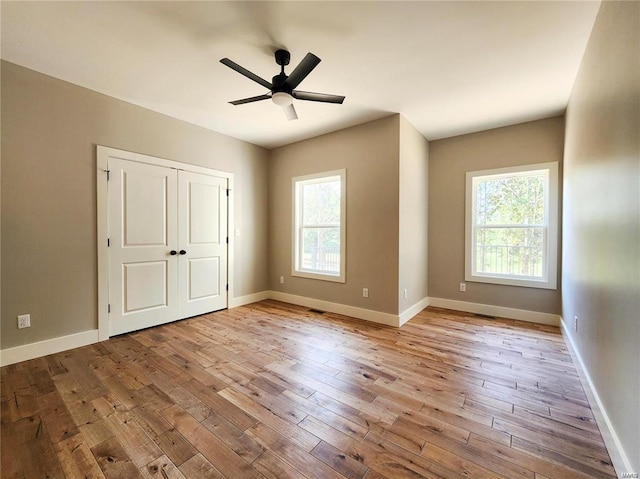 unfurnished bedroom with ceiling fan and light hardwood / wood-style flooring