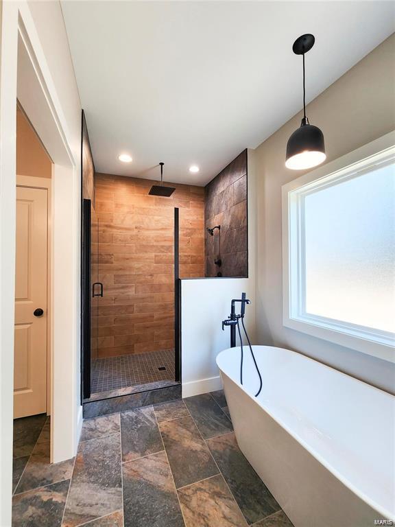 bathroom featuring independent shower and bath