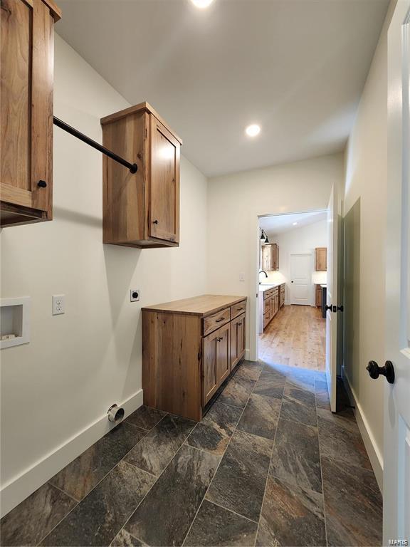 laundry area with hookup for a washing machine, hookup for an electric dryer, and sink