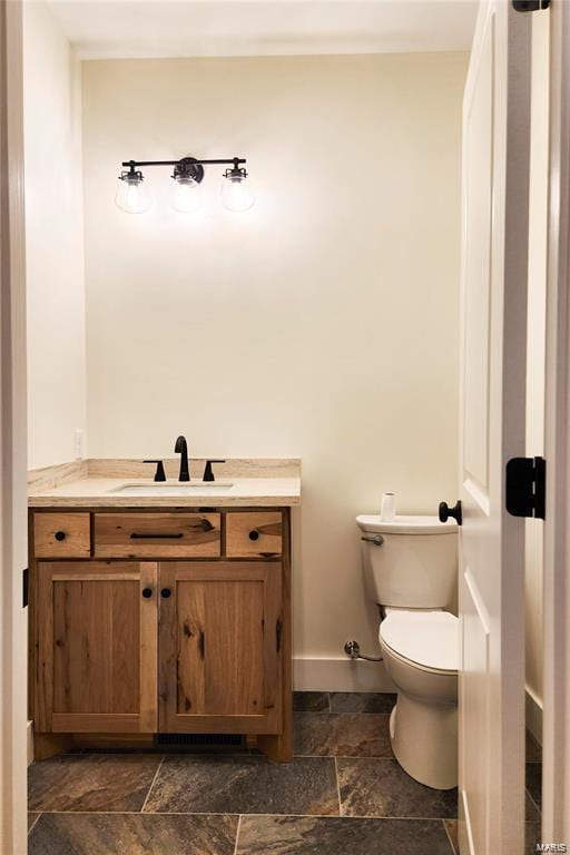 bathroom featuring toilet and vanity