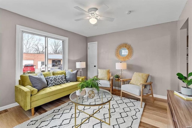 sitting room with ceiling fan and light hardwood / wood-style flooring