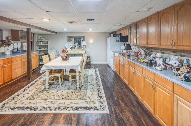 kitchen featuring backsplash, white range with electric cooktop, a drop ceiling, and dark hardwood / wood-style floors