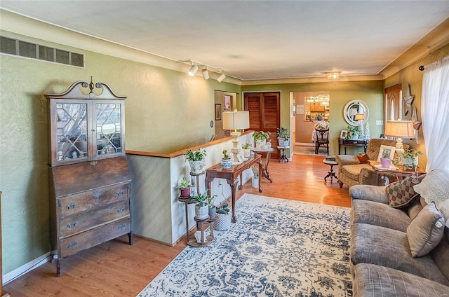 living room with track lighting and hardwood / wood-style floors