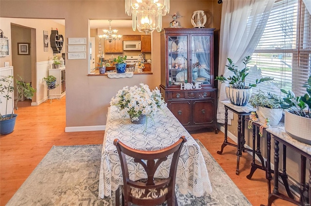 dining room featuring an inviting chandelier and light hardwood / wood-style floors