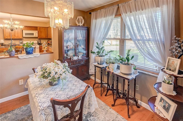 dining room featuring a chandelier and hardwood / wood-style floors