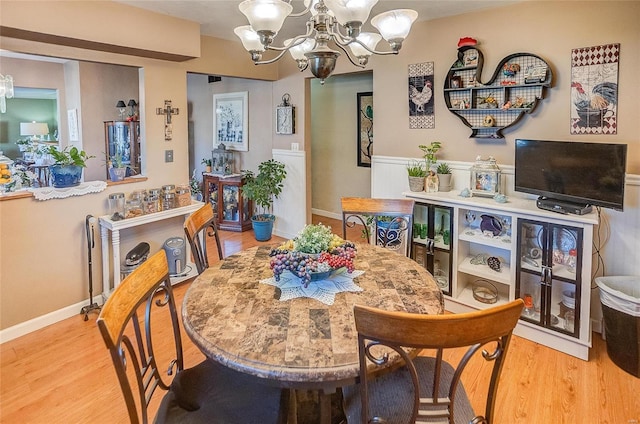 dining room with a chandelier and hardwood / wood-style flooring