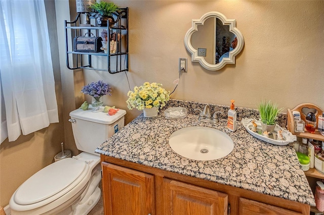 bathroom featuring toilet and vanity