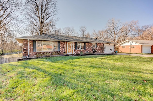 ranch-style home with a front yard and a garage