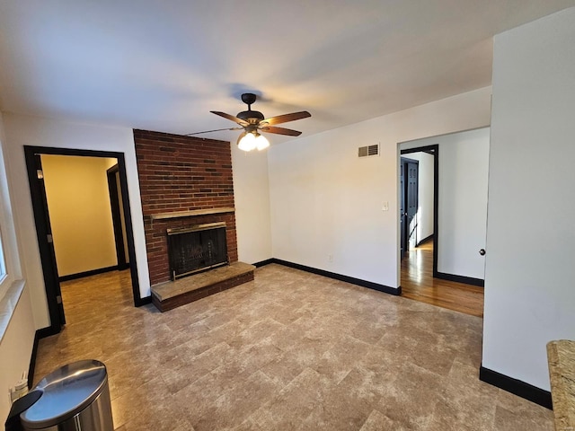 unfurnished living room with a fireplace and ceiling fan