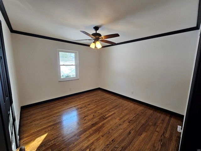 empty room with ornamental molding, ceiling fan, and dark hardwood / wood-style floors