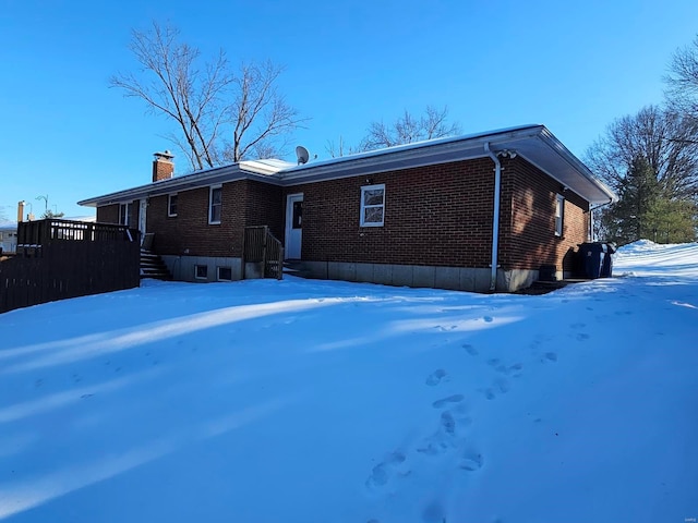 view of snow covered rear of property