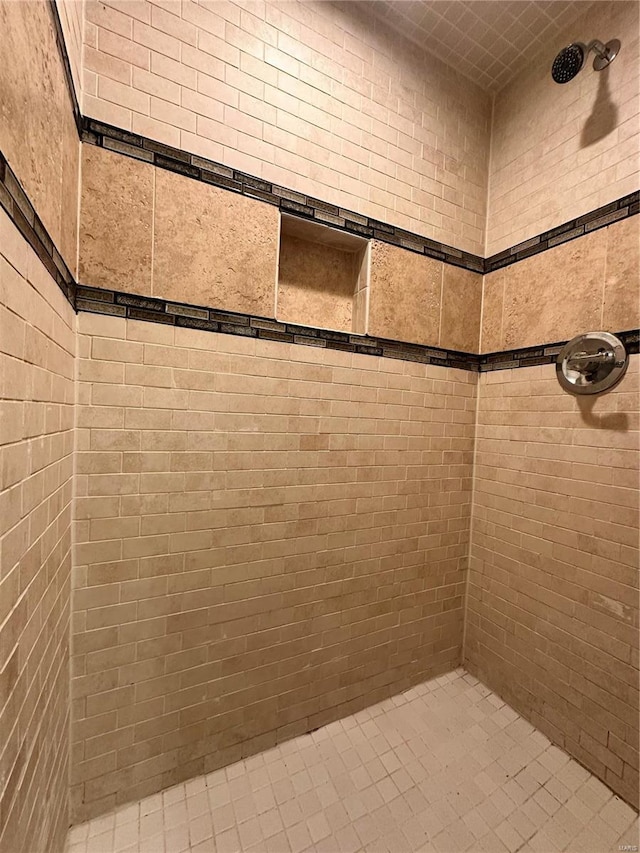 bathroom with a tile shower