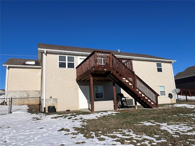 snow covered property with a deck