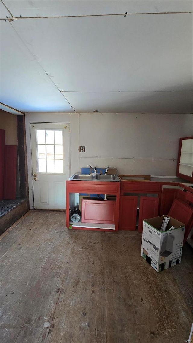 miscellaneous room with hardwood / wood-style flooring and sink