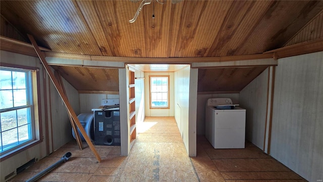 additional living space featuring lofted ceiling and washer / dryer