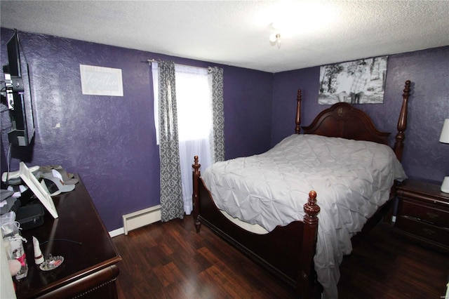 bedroom with a textured ceiling, dark wood-type flooring, and a baseboard heating unit