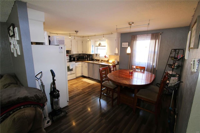 dining area with dark hardwood / wood-style flooring and sink