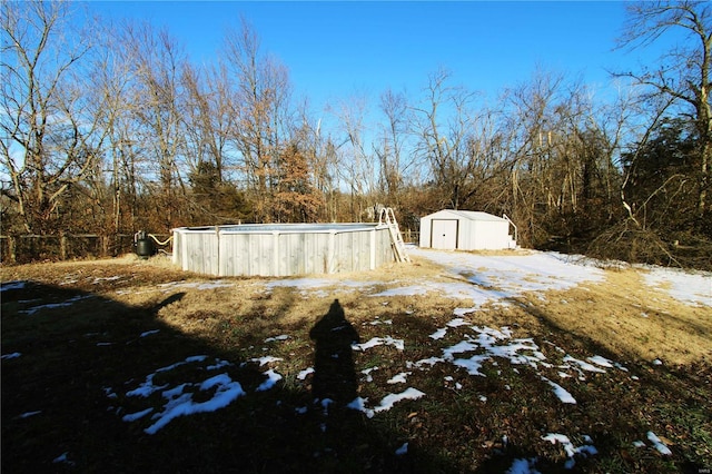 snowy yard with a shed