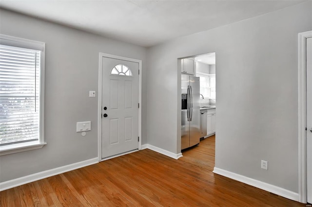 entryway with a healthy amount of sunlight and light hardwood / wood-style floors