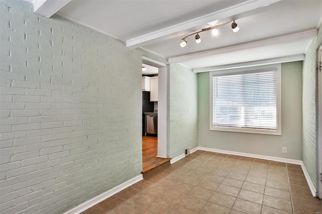 spare room featuring brick wall, light tile patterned floors, and beam ceiling