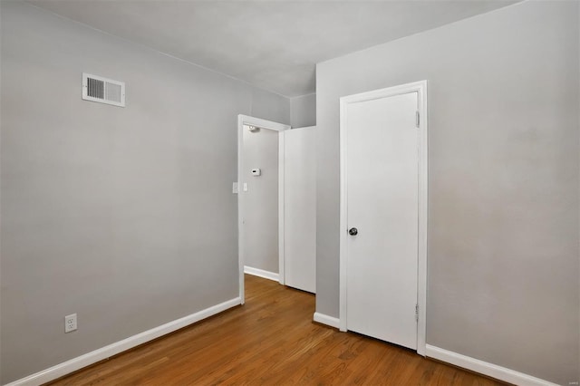 unfurnished room with hardwood / wood-style floors