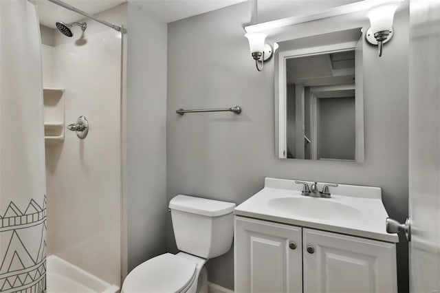 bathroom featuring toilet, vanity, and a shower