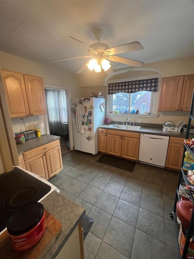 kitchen with ceiling fan, sink, white appliances, and light brown cabinetry