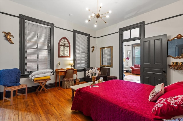 bedroom featuring hardwood / wood-style flooring and a chandelier