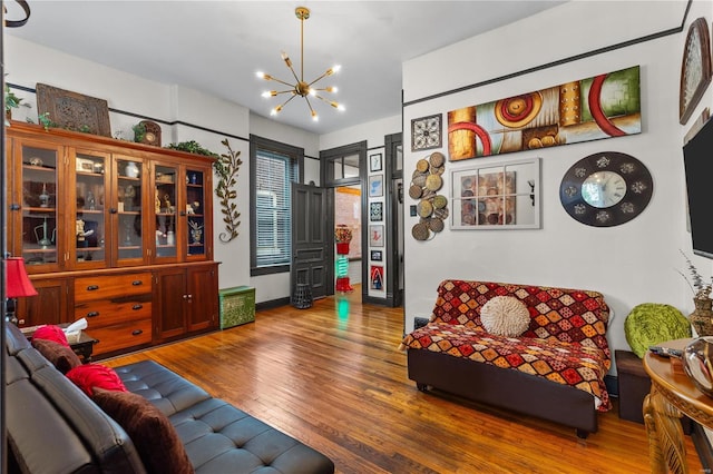 living room with hardwood / wood-style floors and a notable chandelier