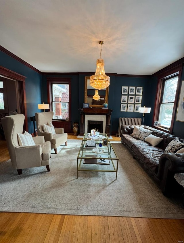 living room with wood-type flooring and ornamental molding