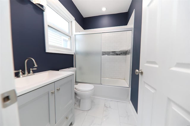 full bathroom featuring bath / shower combo with glass door, toilet, and vanity