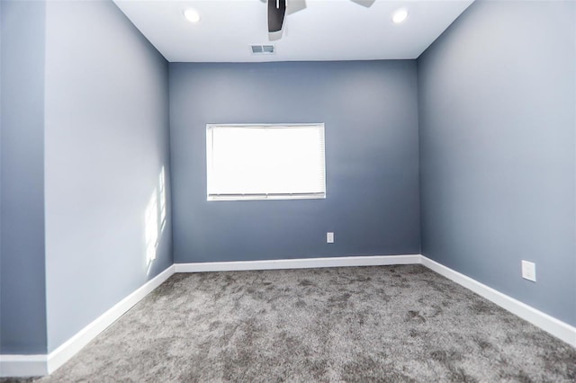 spare room with carpet flooring and ceiling fan