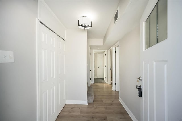 hallway with wood-type flooring