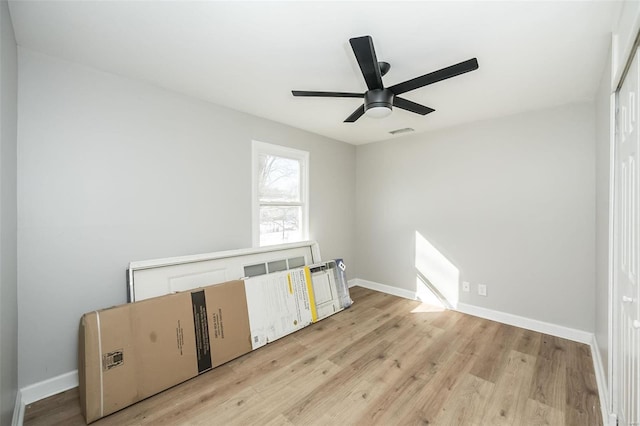 spare room featuring light wood-type flooring and ceiling fan