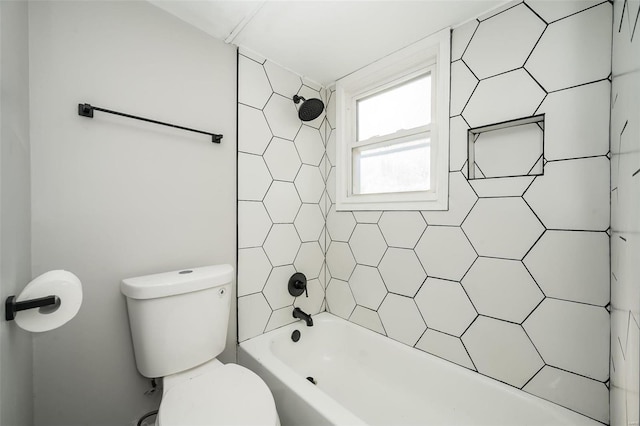 bathroom featuring tiled shower / bath and toilet