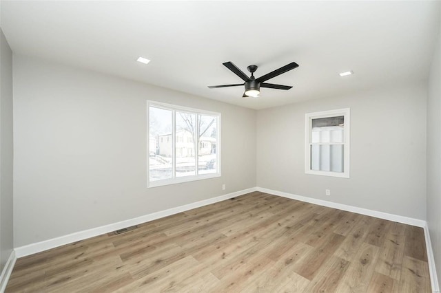 spare room with ceiling fan and light hardwood / wood-style flooring