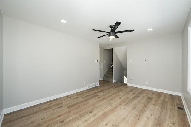 empty room with light hardwood / wood-style floors and ceiling fan