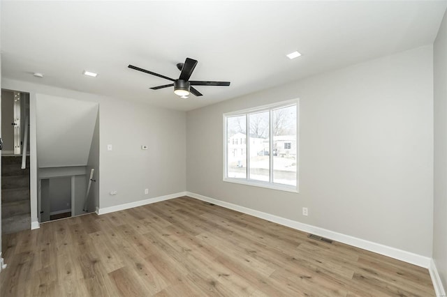 empty room featuring ceiling fan and light hardwood / wood-style flooring