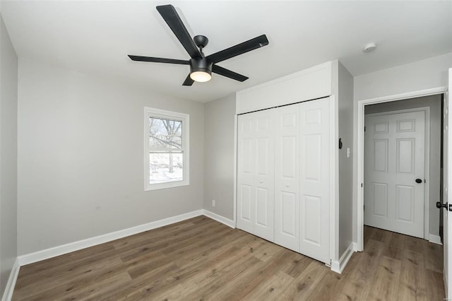 unfurnished bedroom with ceiling fan, light hardwood / wood-style floors, and a closet