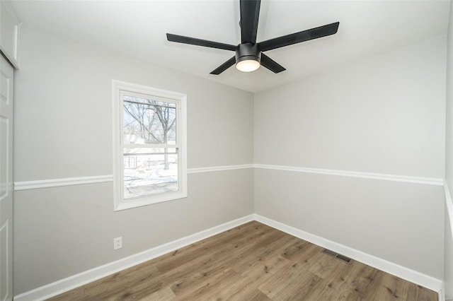 spare room featuring ceiling fan and hardwood / wood-style flooring