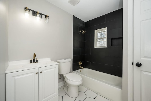 full bathroom with toilet, tiled shower / bath, and vanity